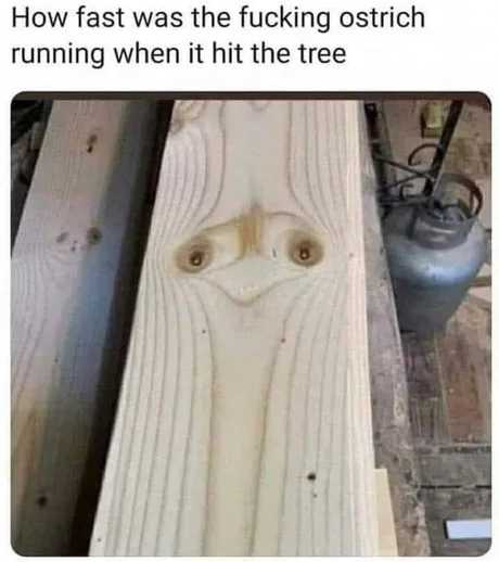 a close up of a wooden table with a face carved into it