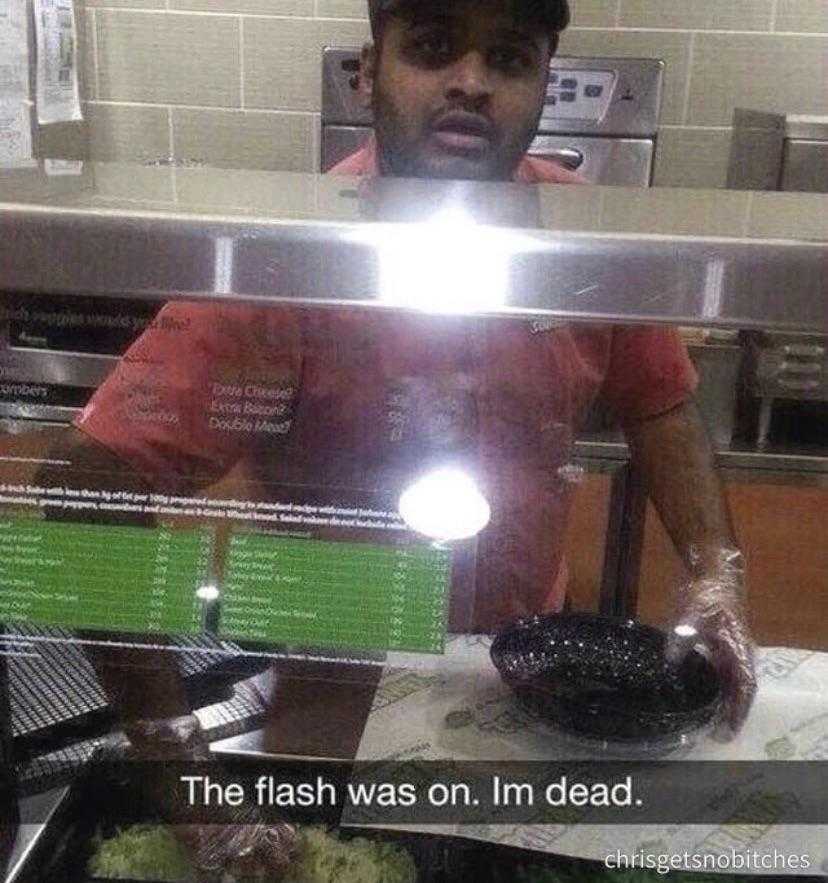 there is a man behind a glass counter with a bowl of food