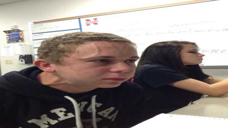 there are two people sitting at a table with a laptop