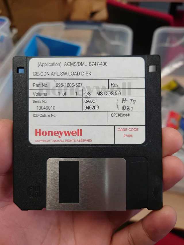 floppy disk in hand with a price tag on it