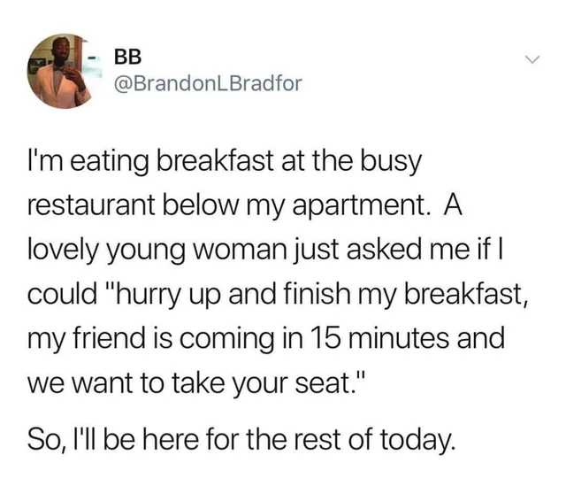 a woman is sitting at a table with a plate of food