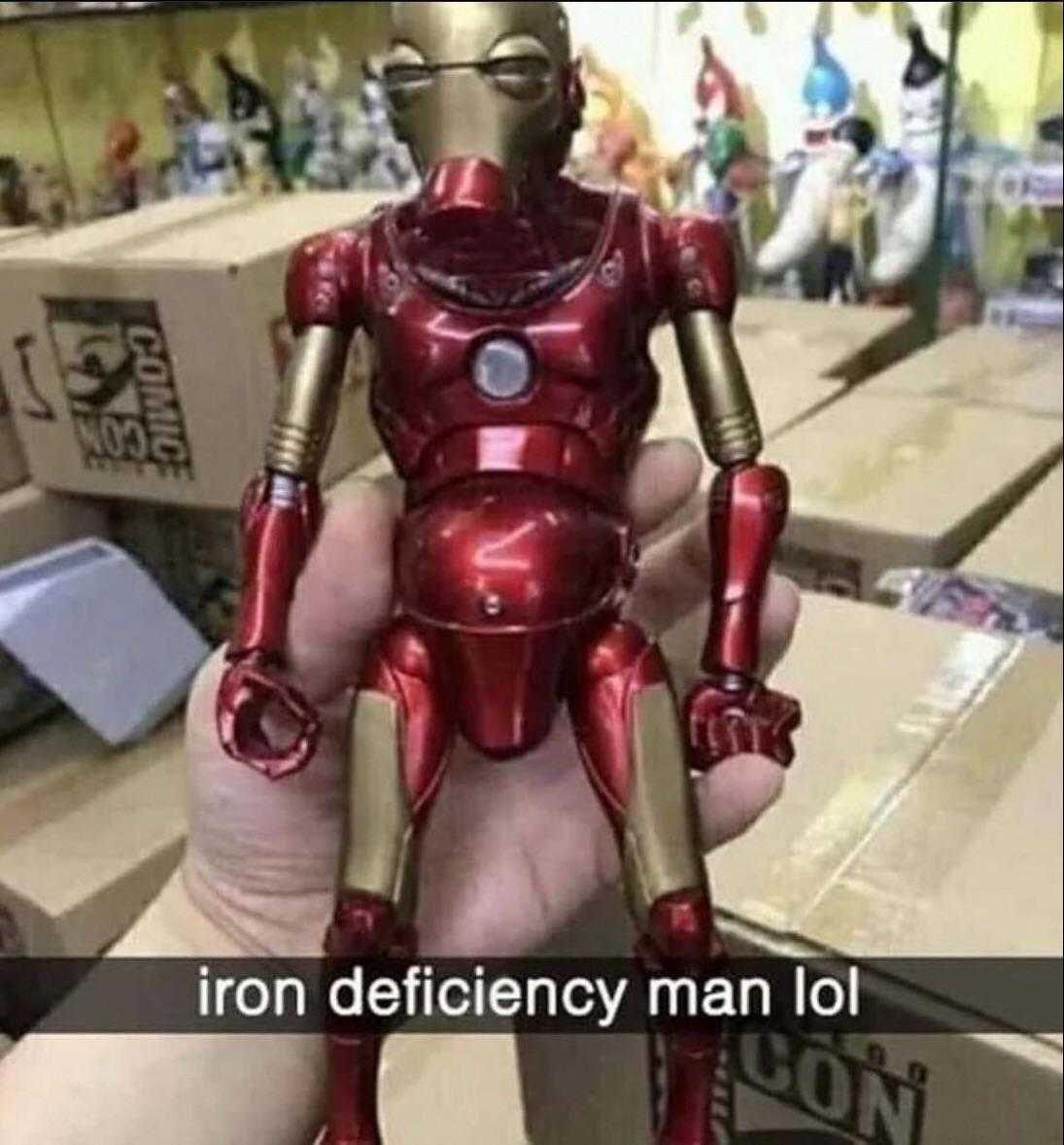 a close up of a person holding a toy iron man