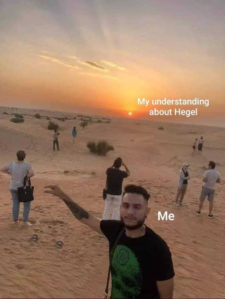 people standing in the sand with a sunset in the background