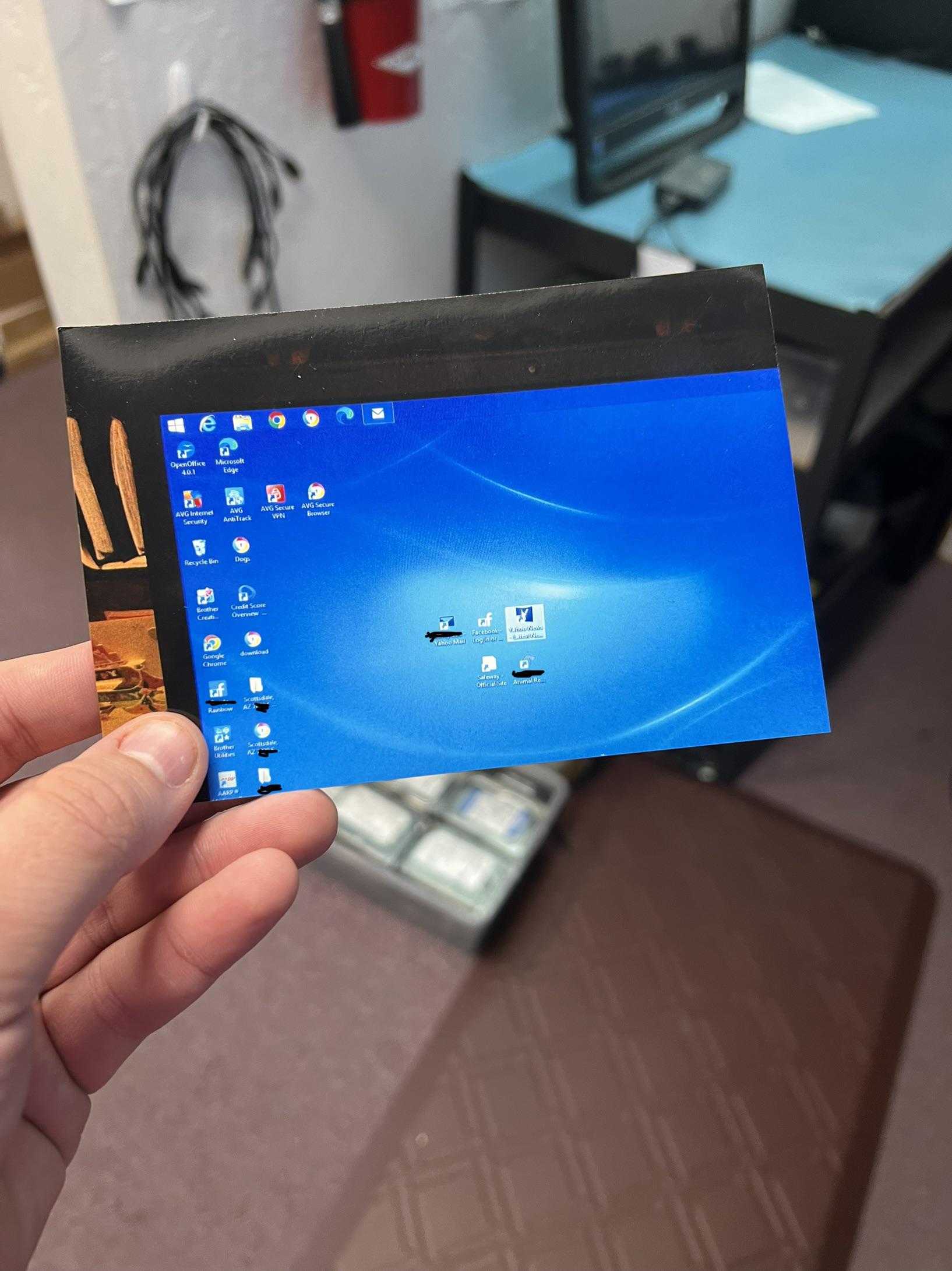 someone holding a small screen with a blue screen on it