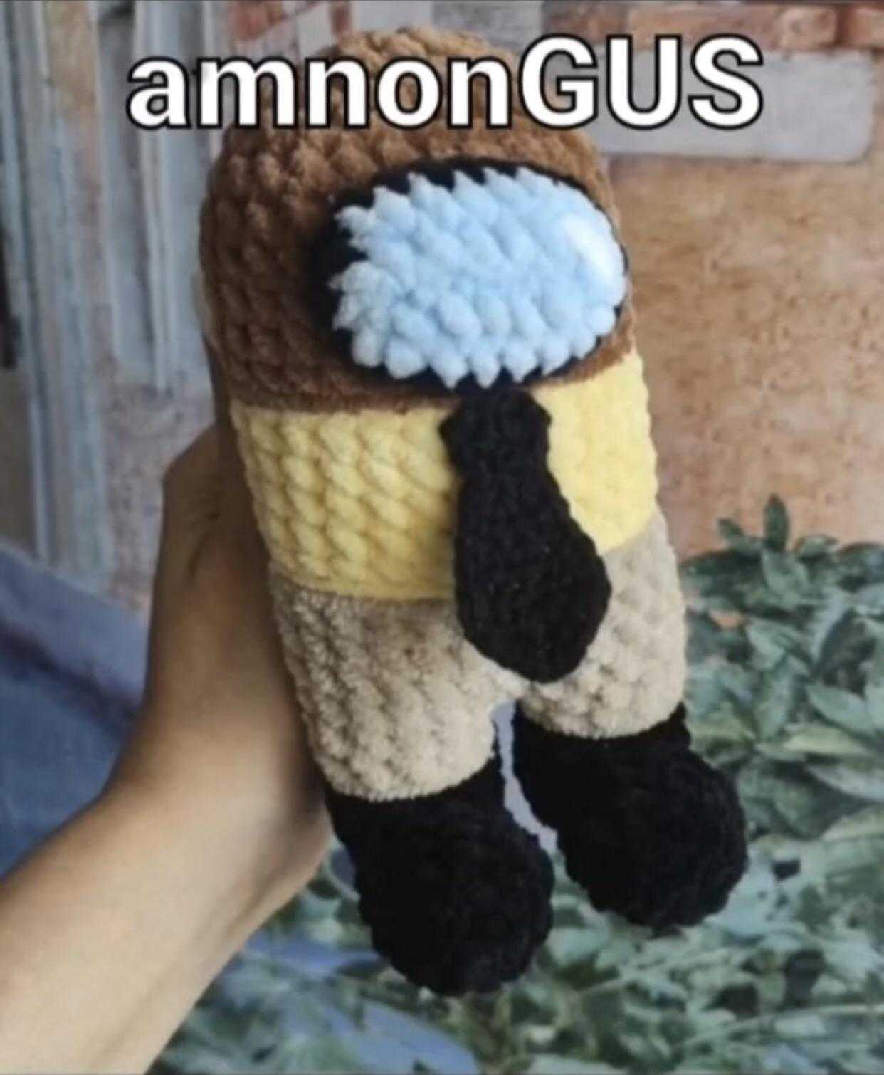 someone is holding a stuffed animal in a knitted hat