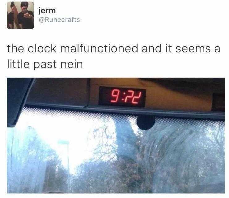 a close up of a clock on a car ' s dashboard with a person in the background