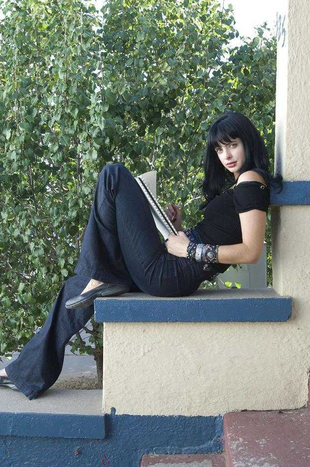 araffe sitting on a ledge reading a book outside