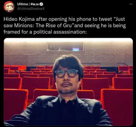 image of a man in a suit and glasses sitting in a theater