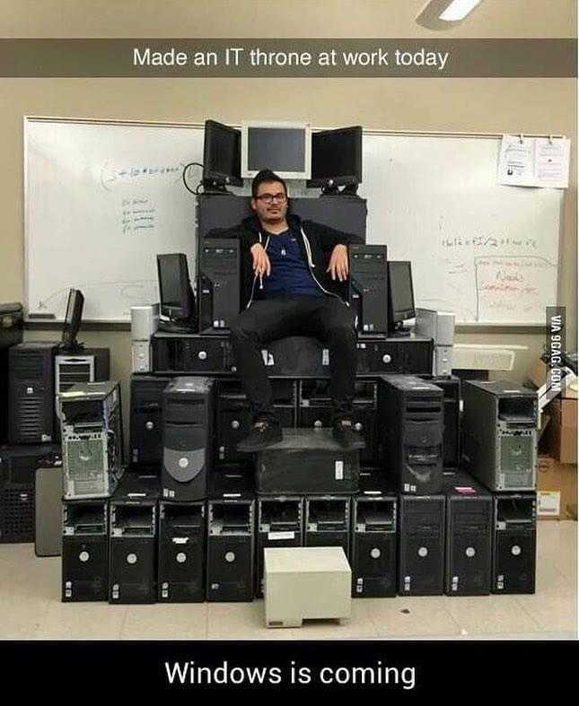 man sitting on top of a pile of computer equipment