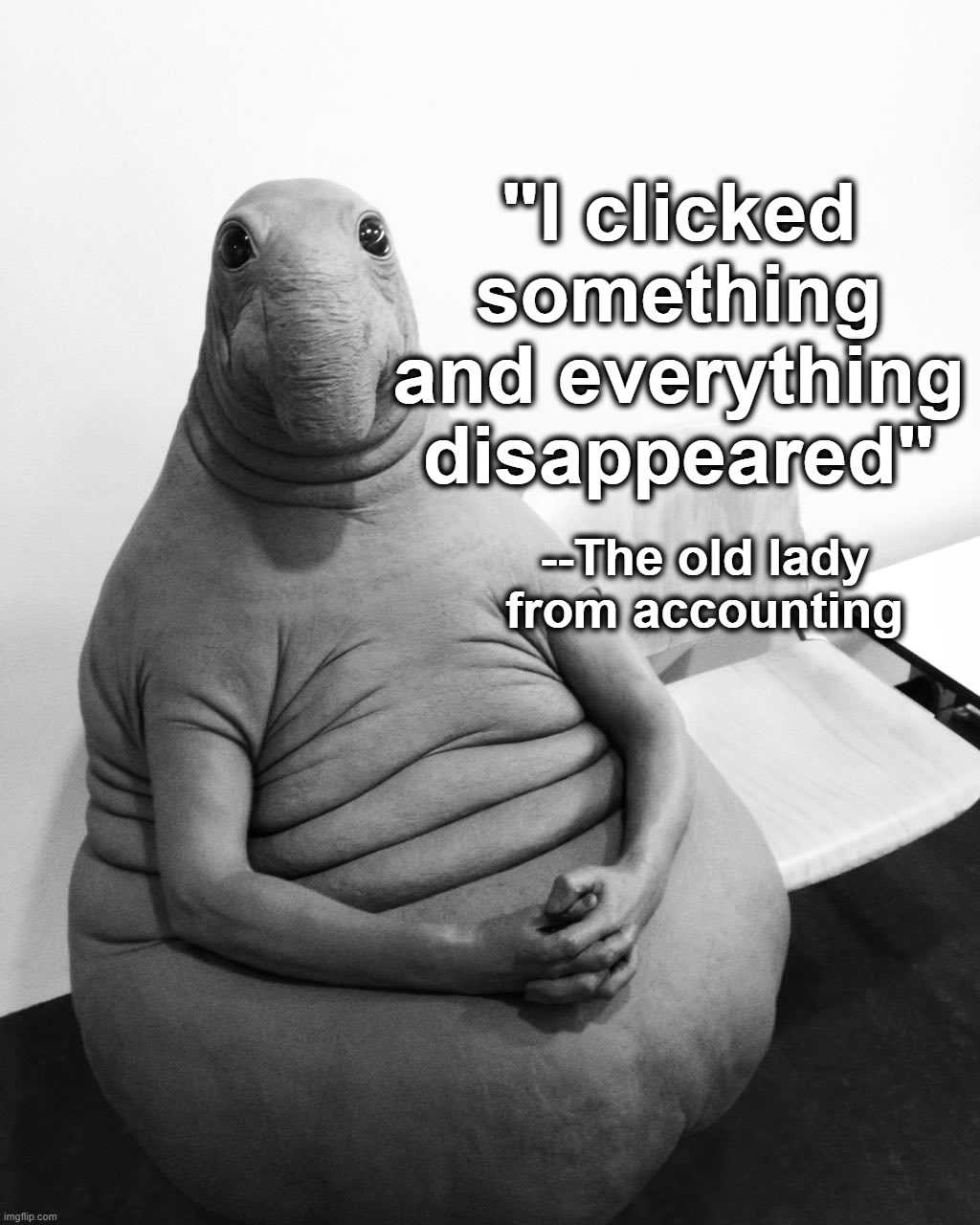 a black and white photo of a fat man sitting on a bean bag