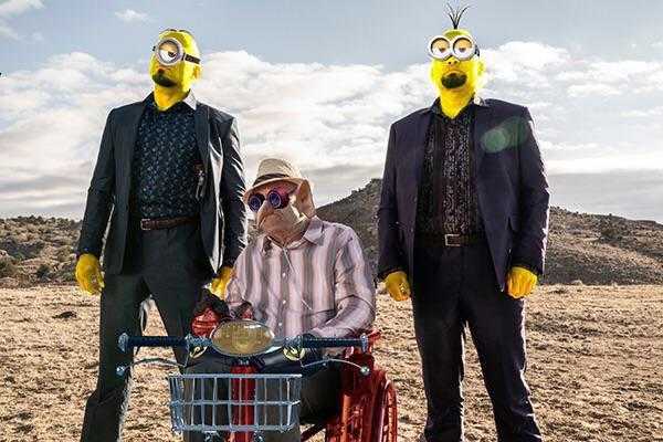 three people in suits and sunglasses stand next to a shopping cart