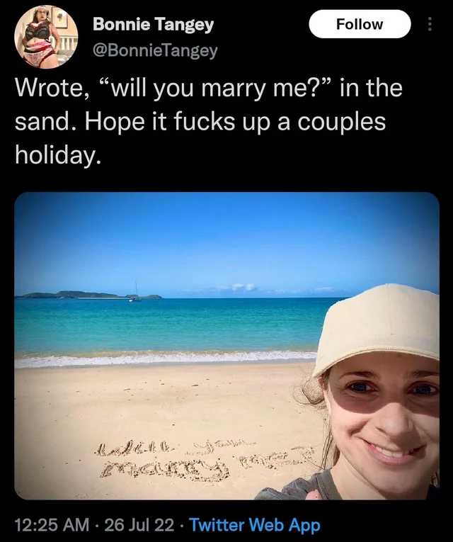 araff tweee of a woman on the beach with a message written in the sand