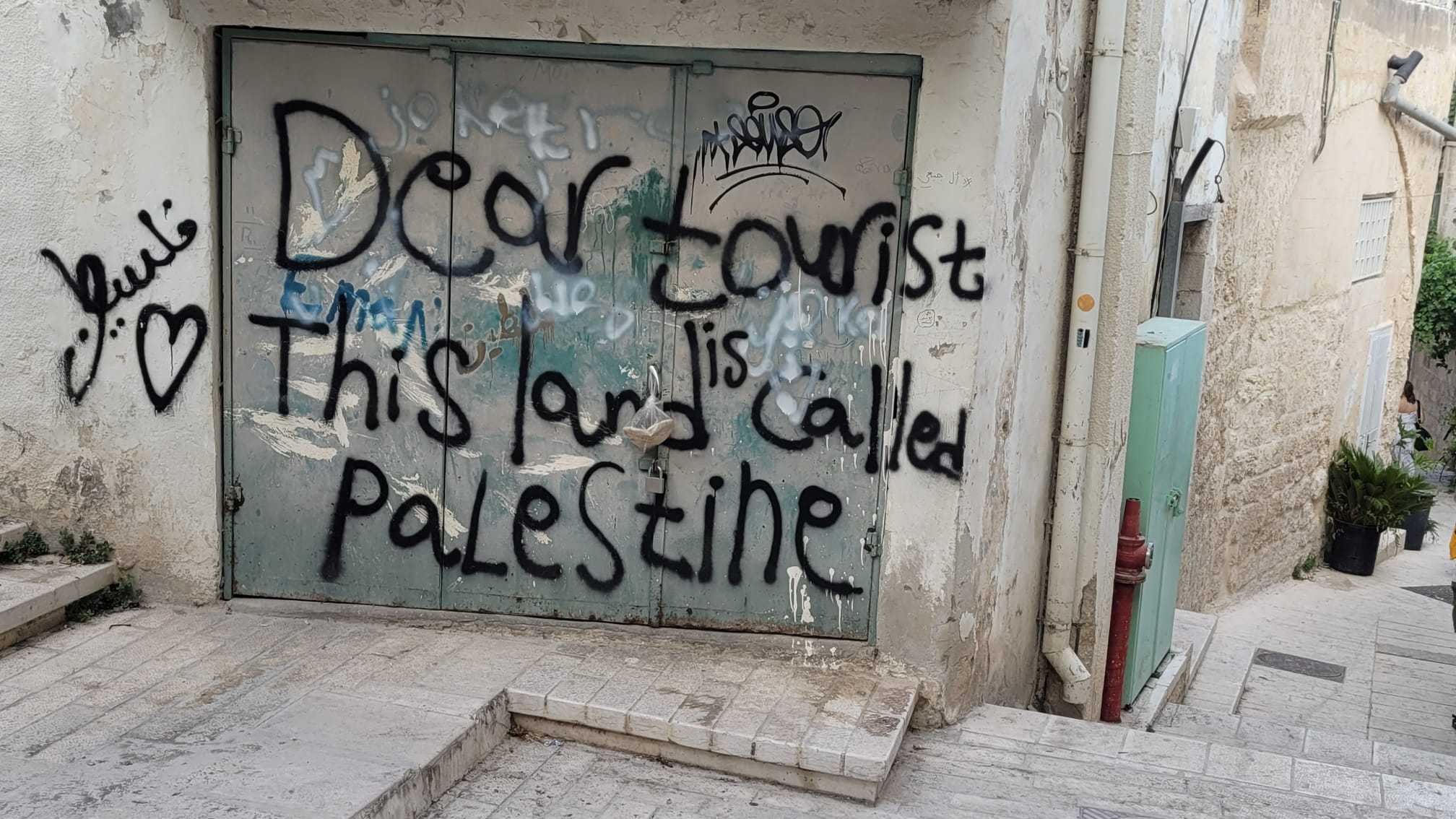 graffiti on a door of a building with a sign that says dear lord