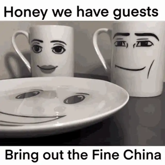 there are two coffee cups with faces on them on a plate