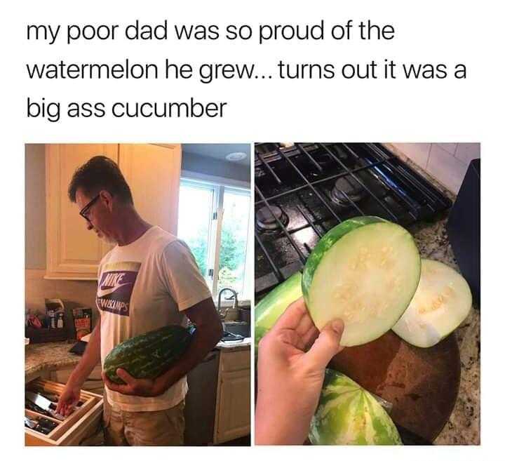 man in a white shirt cutting a cucumber on a cutting board