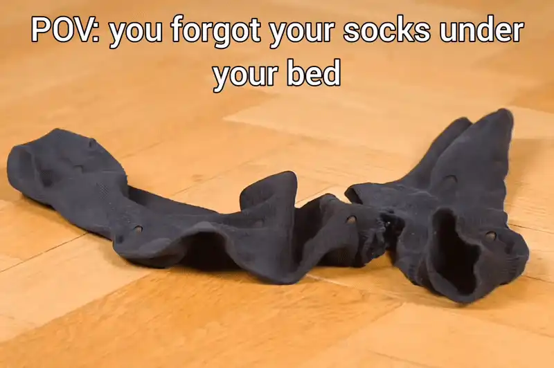 there is a black object on the floor with a caption that reads pov you forgot your socks under your bed