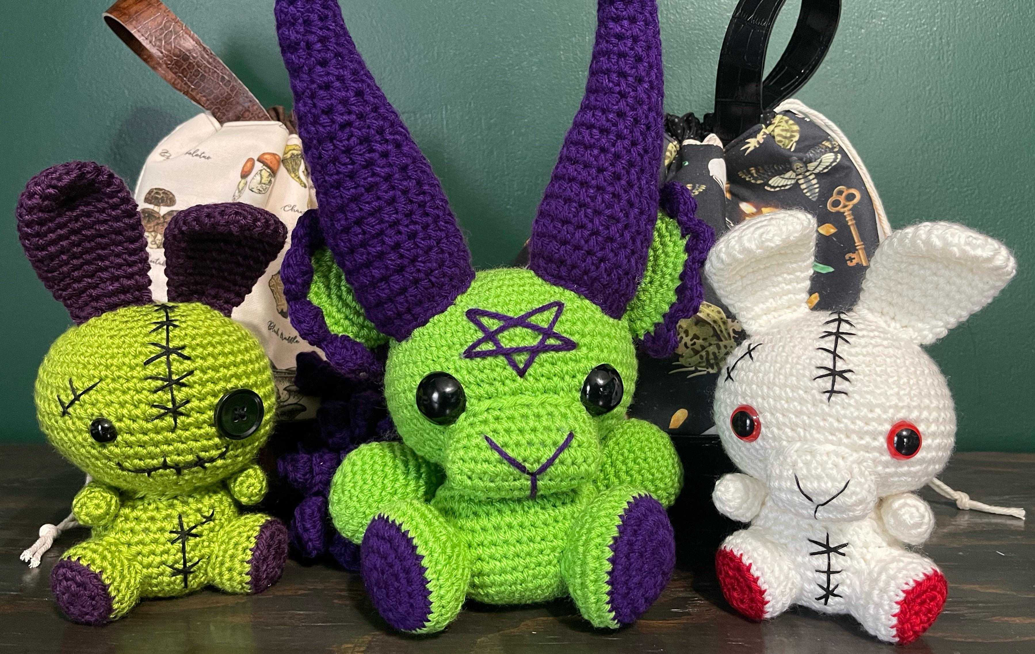 three stuffed animals are sitting next to each other on a table