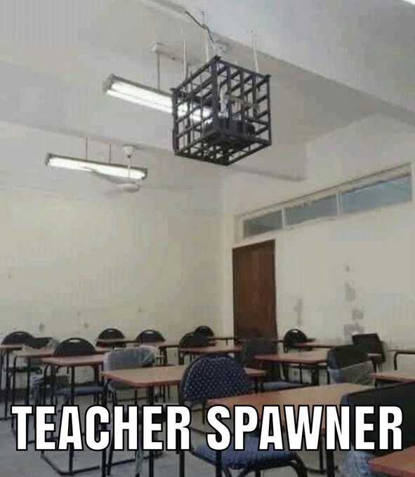 there is a classroom with tables and chairs and a lamp hanging from the ceiling