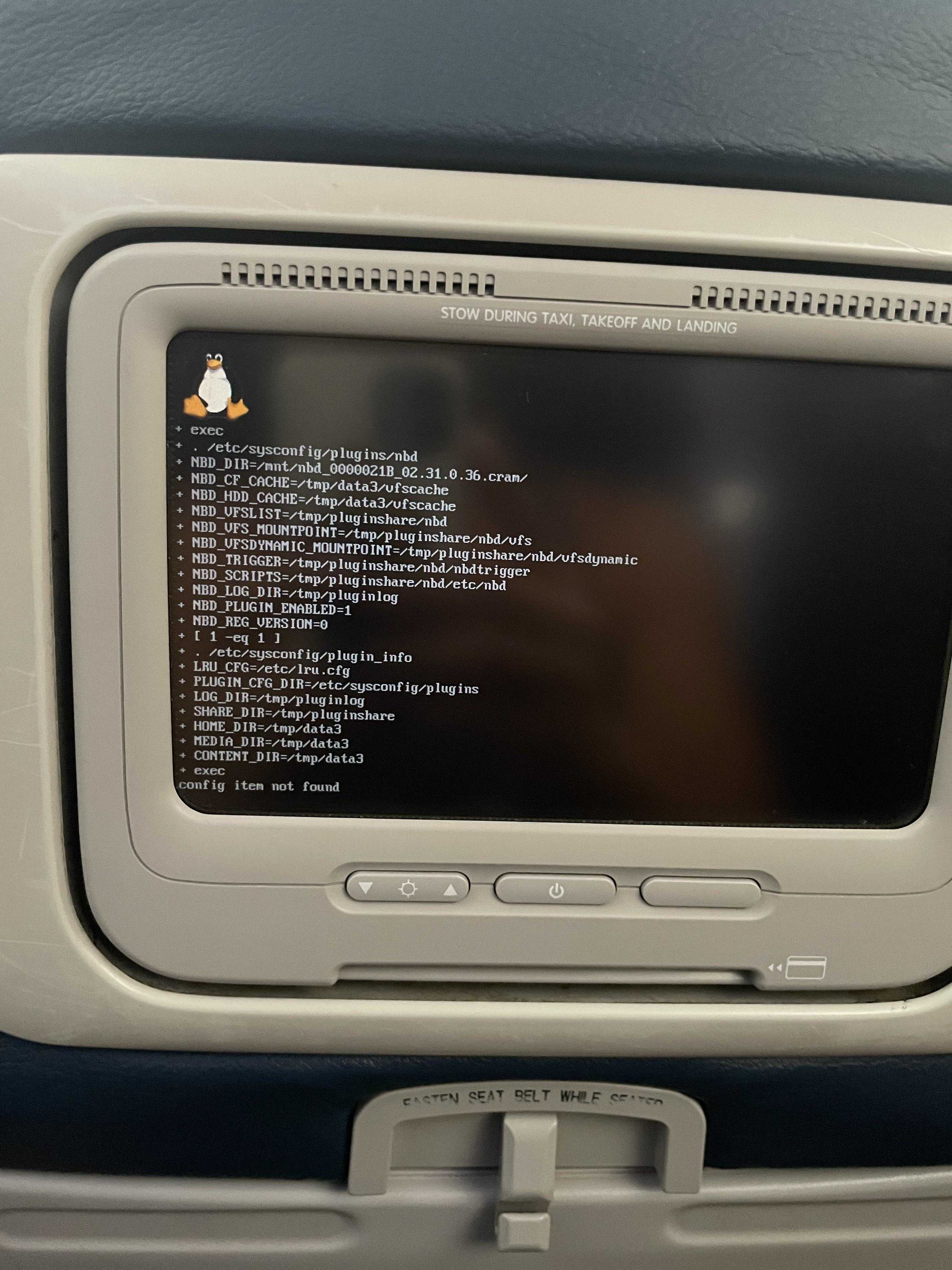 a close up of a monitor on a plane with a keyboard