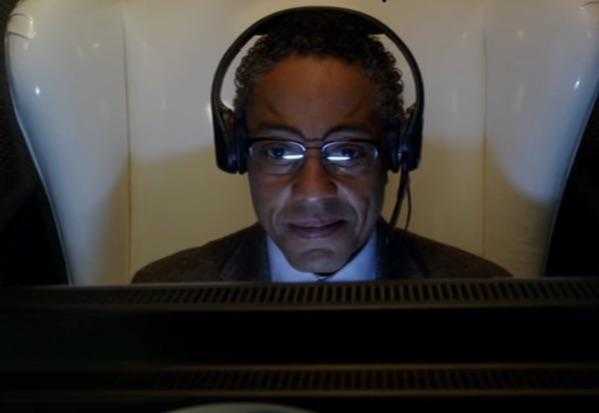 there is a man wearing headphones and a suit sitting in front of a computer