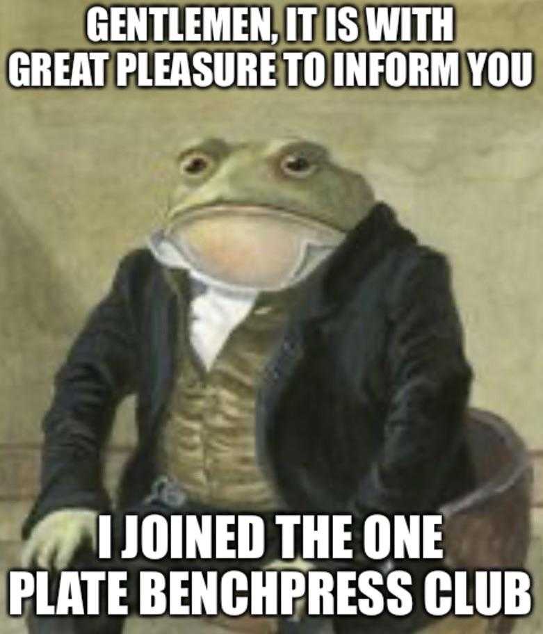 a close up of a frog in a suit sitting on a chair