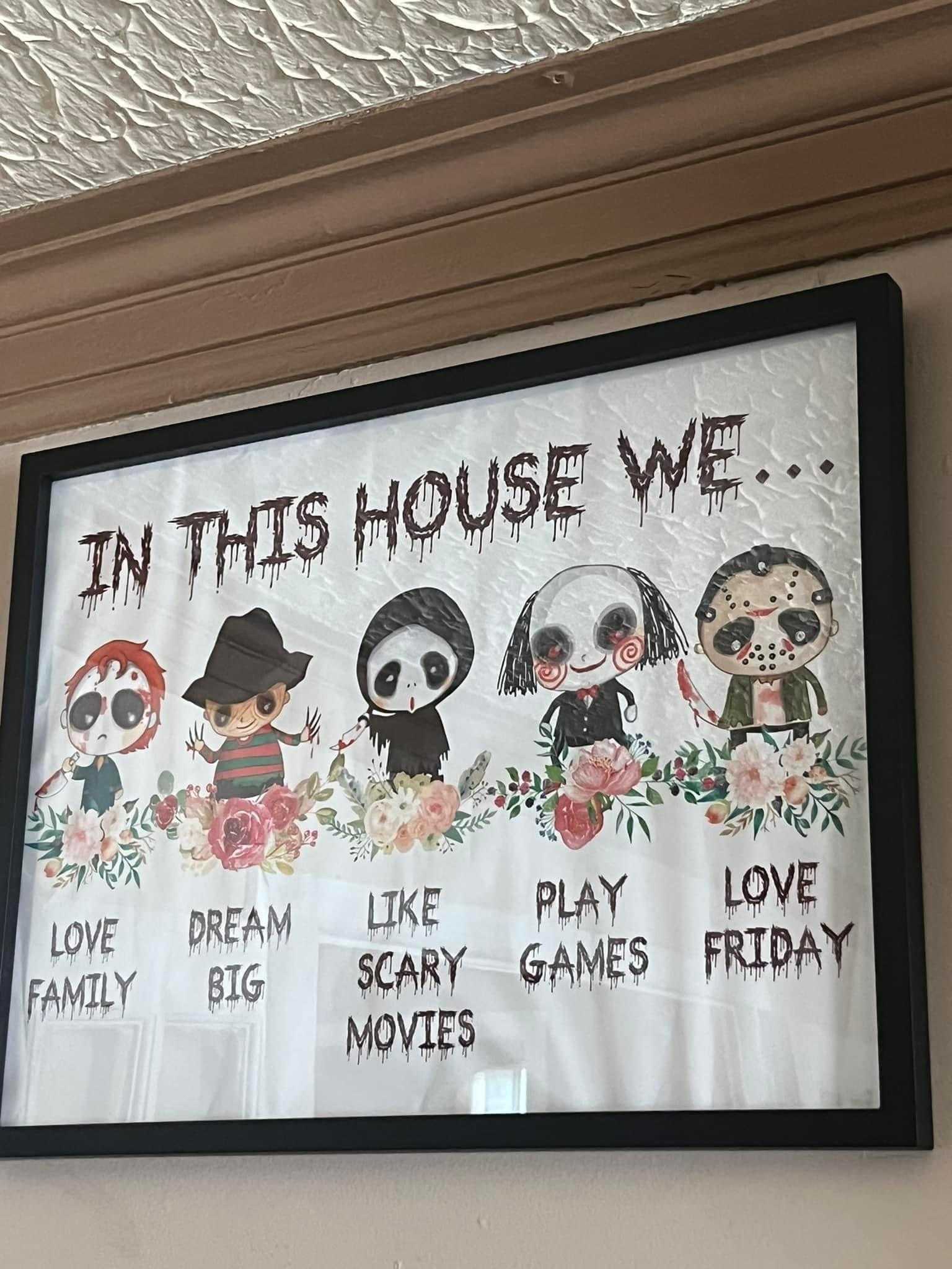 there is a sign that says in this house we love, like, scary games, movies, friday