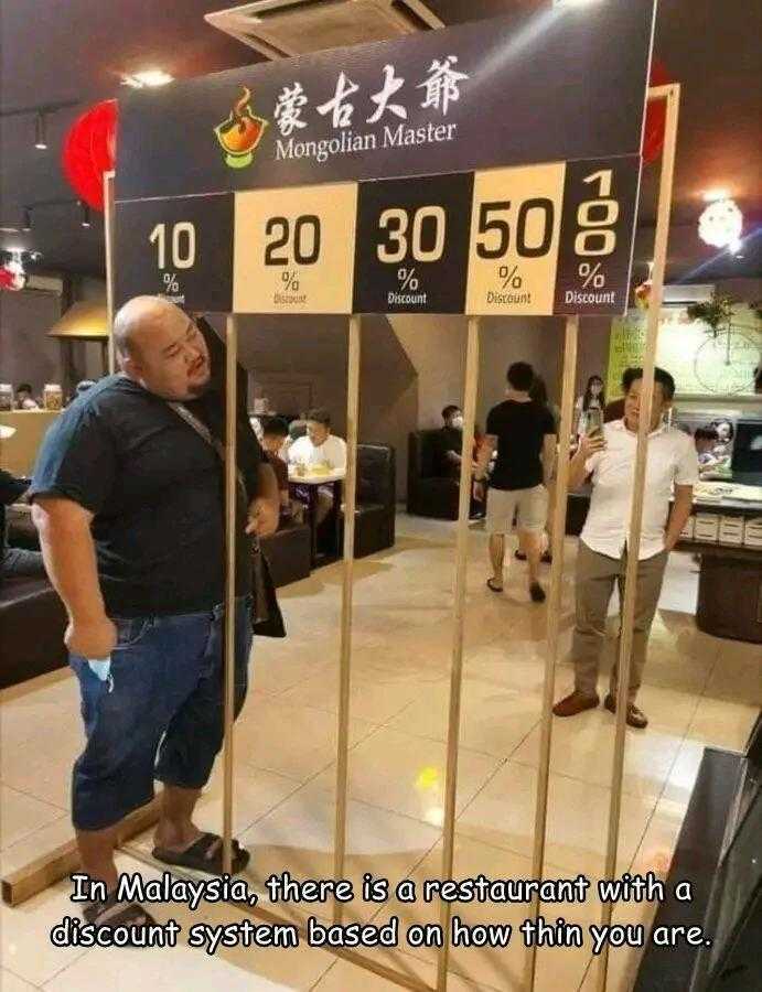 man standing in front of a restaurant with a clock on it