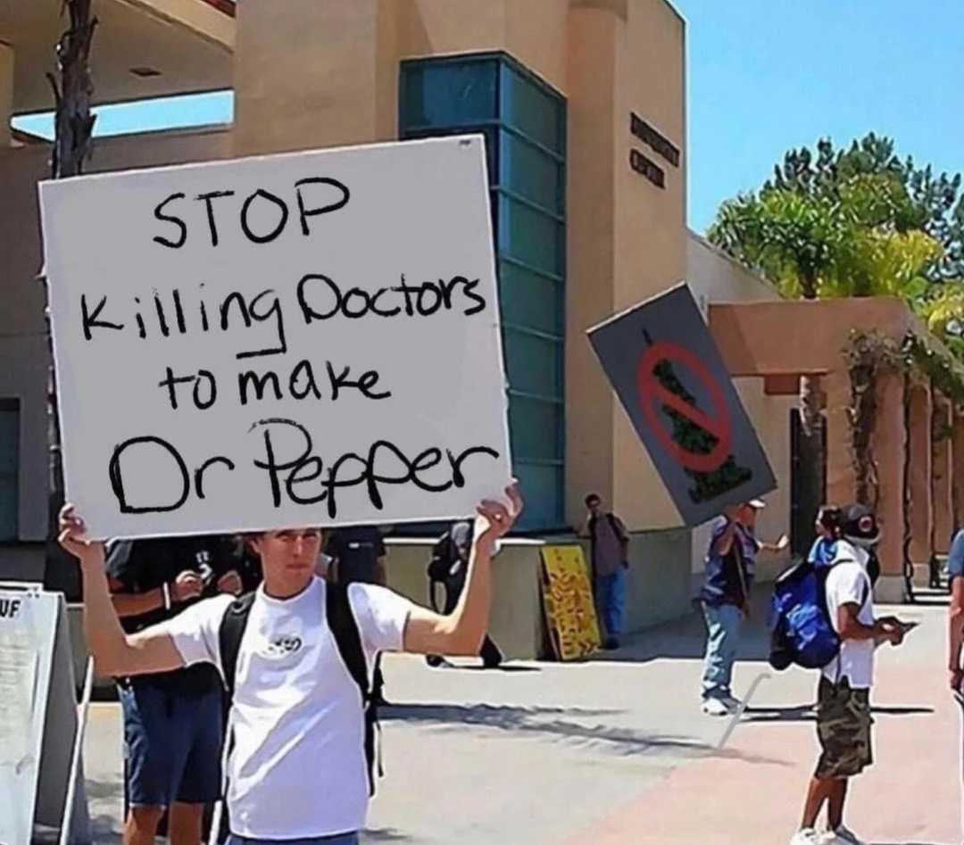 there is a man holding a sign that says stop killing cops to make or die