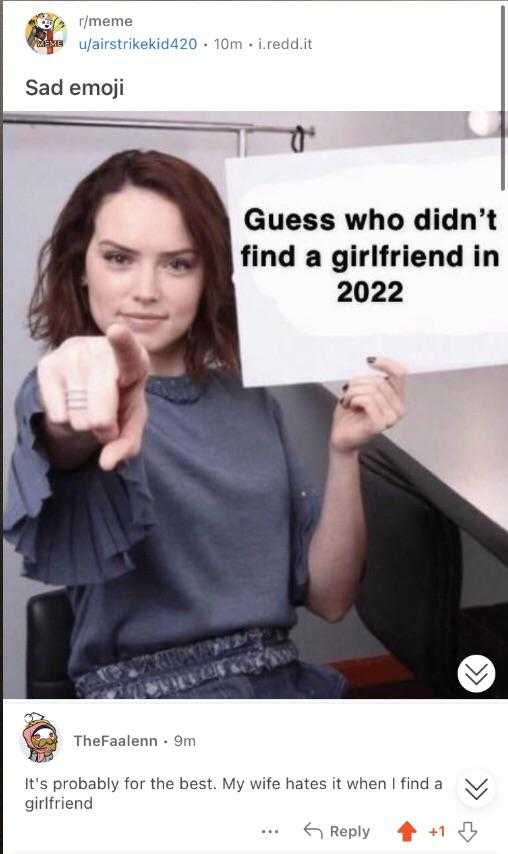 woman holding a sign that says guess who didn ' t find a girlfriend in 2022