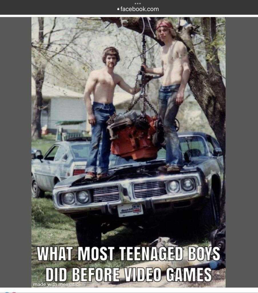 there are two men standing on top of a car with a motorcycle