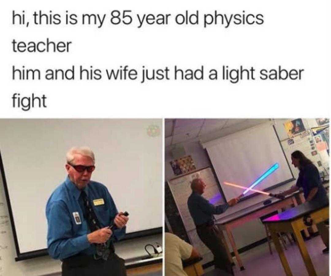 a picture taken from a video of a man in a classroom with a light saber