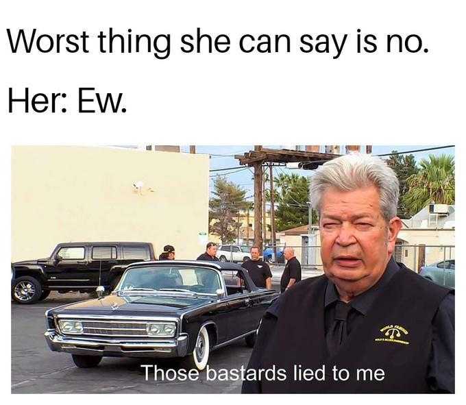 man in black shirt standing in front of a car