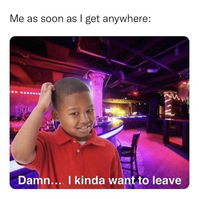 kid in a red shirt standing in a bar with a purple light