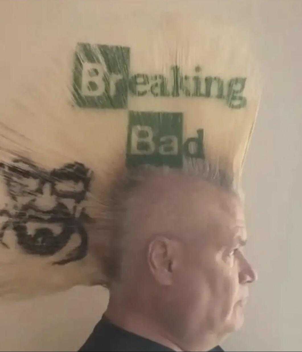 man with a mohawk with a sign on it