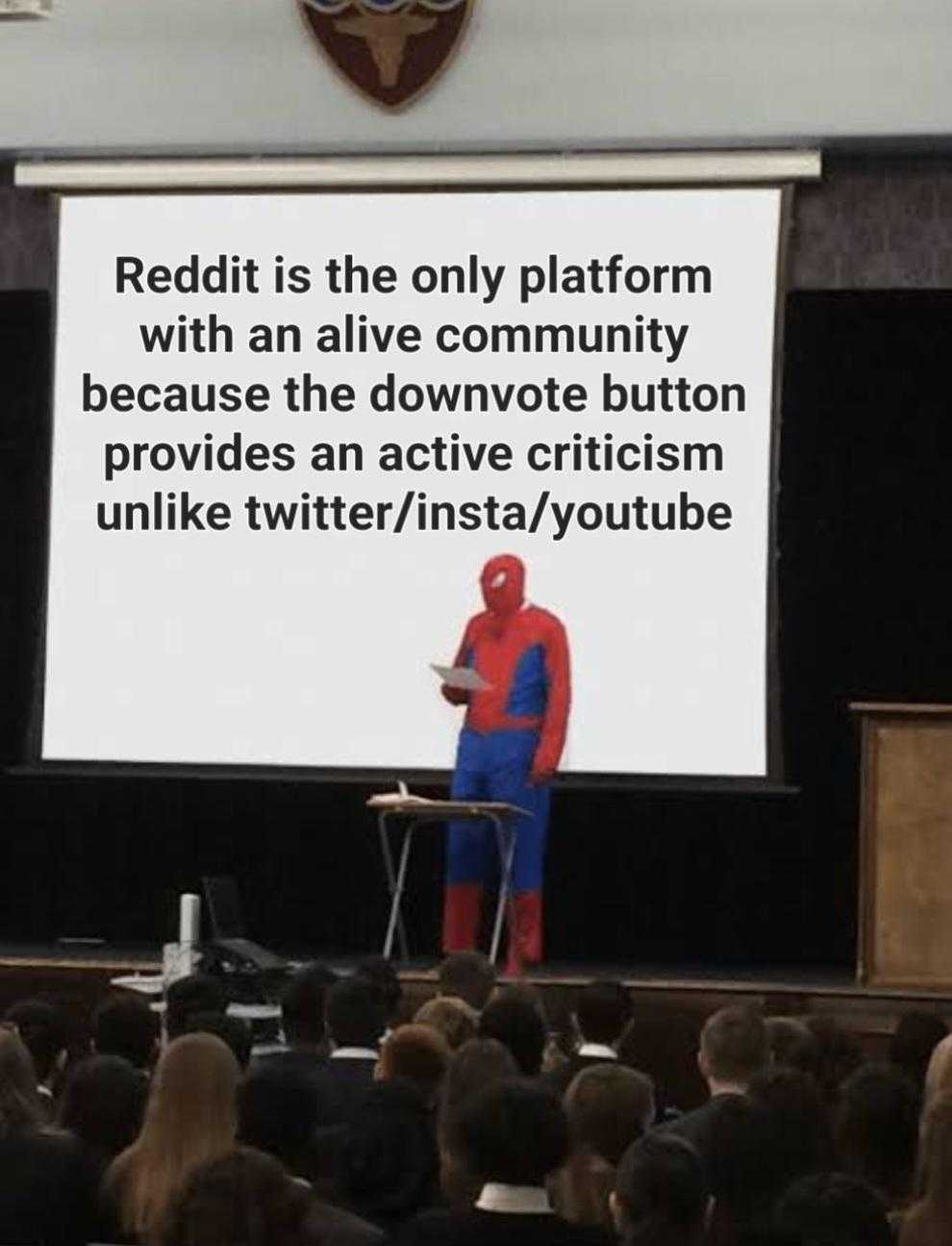 someone dressed as spider man giving a presentation at a conference