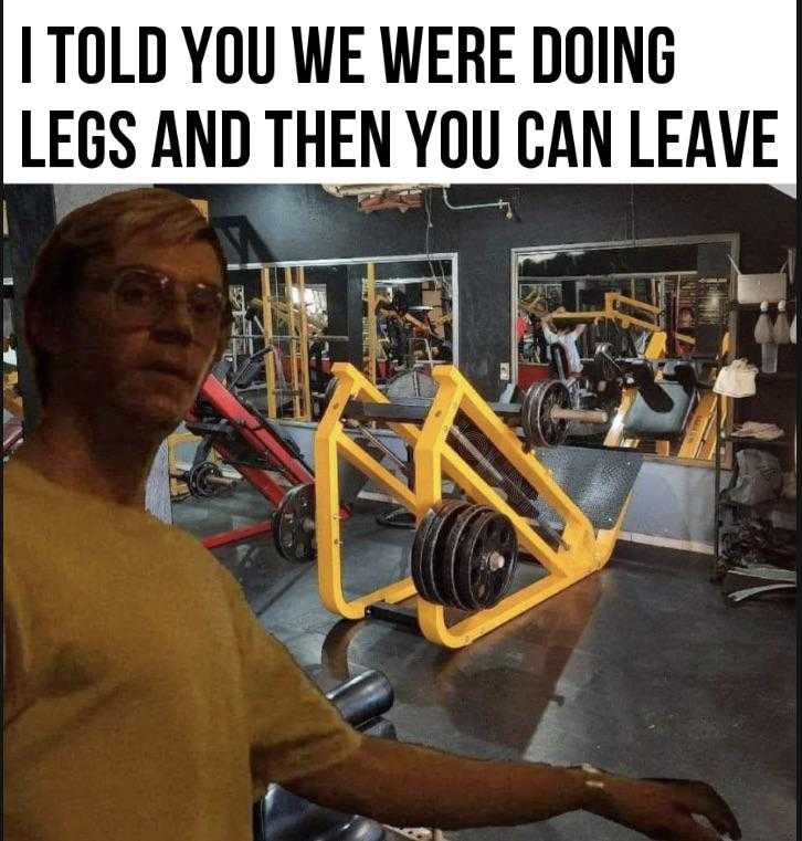 man in a gym with a barbell and a sign that says, i told you we were doing legs and then you can leave