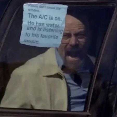 man in a car with a note taped to his face