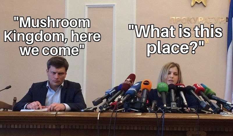 there are two people sitting at a table with microphones