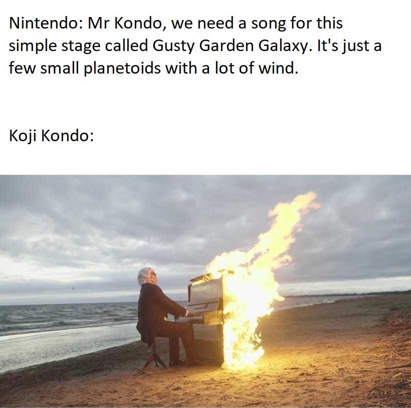 there is a man sitting at a piano on the beach with a fire