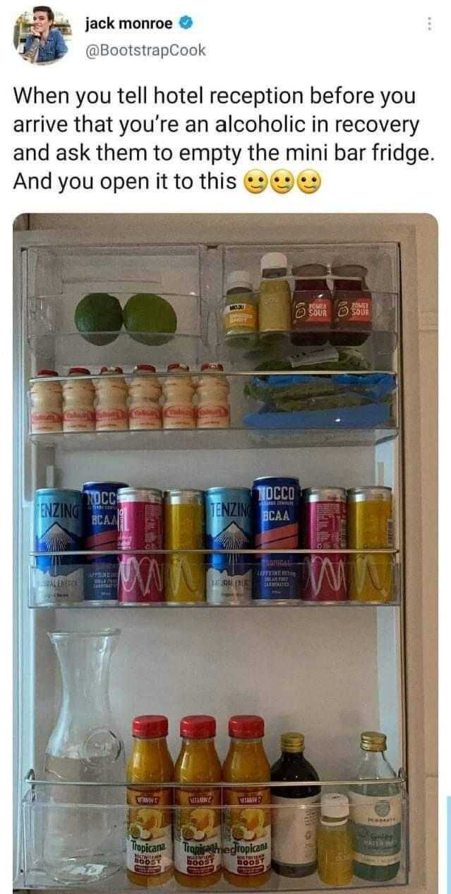 refrigerator with drinks and condiments on shelves in a kitchen