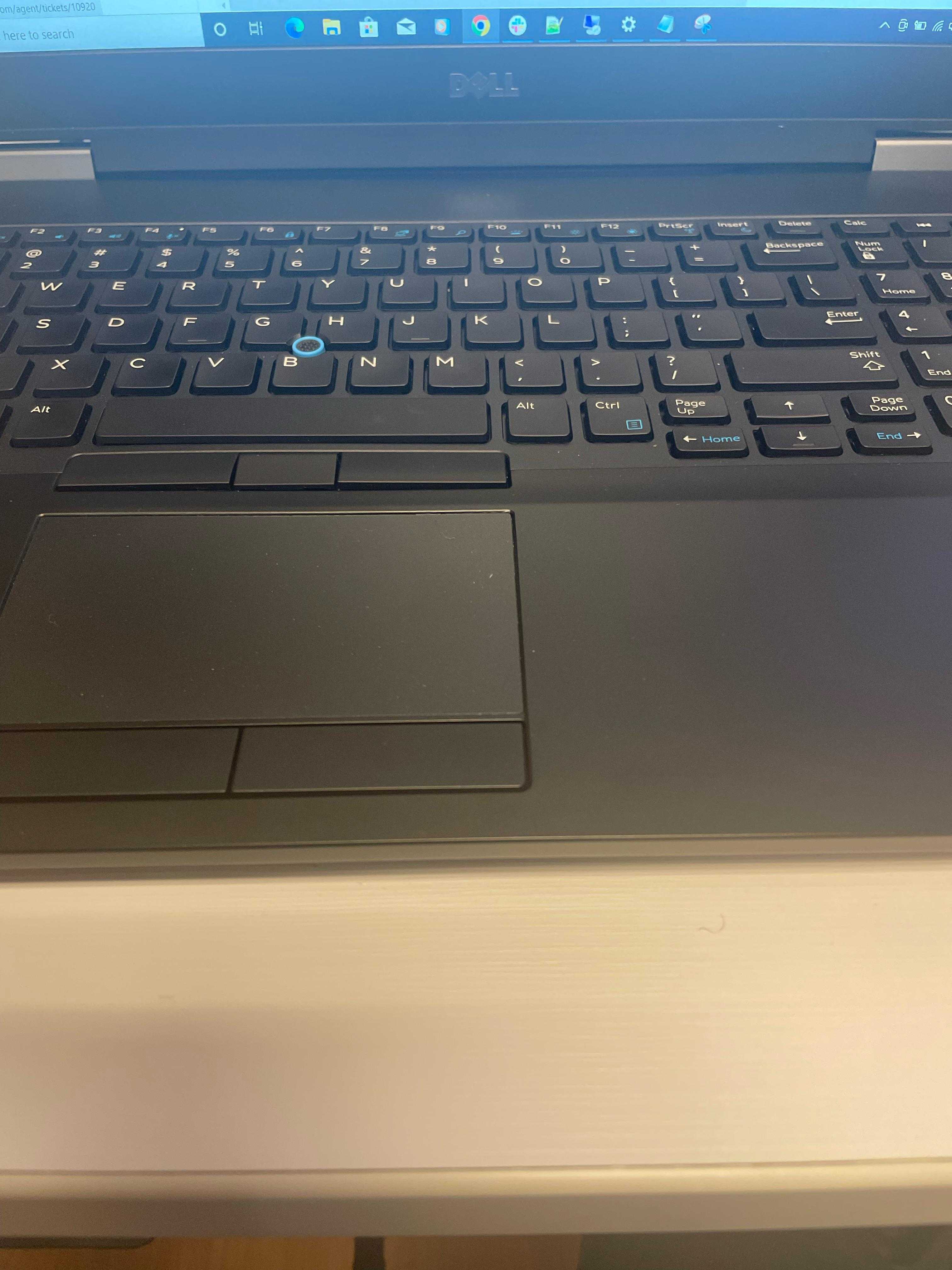 there is a laptop computer sitting on a desk with a keyboard