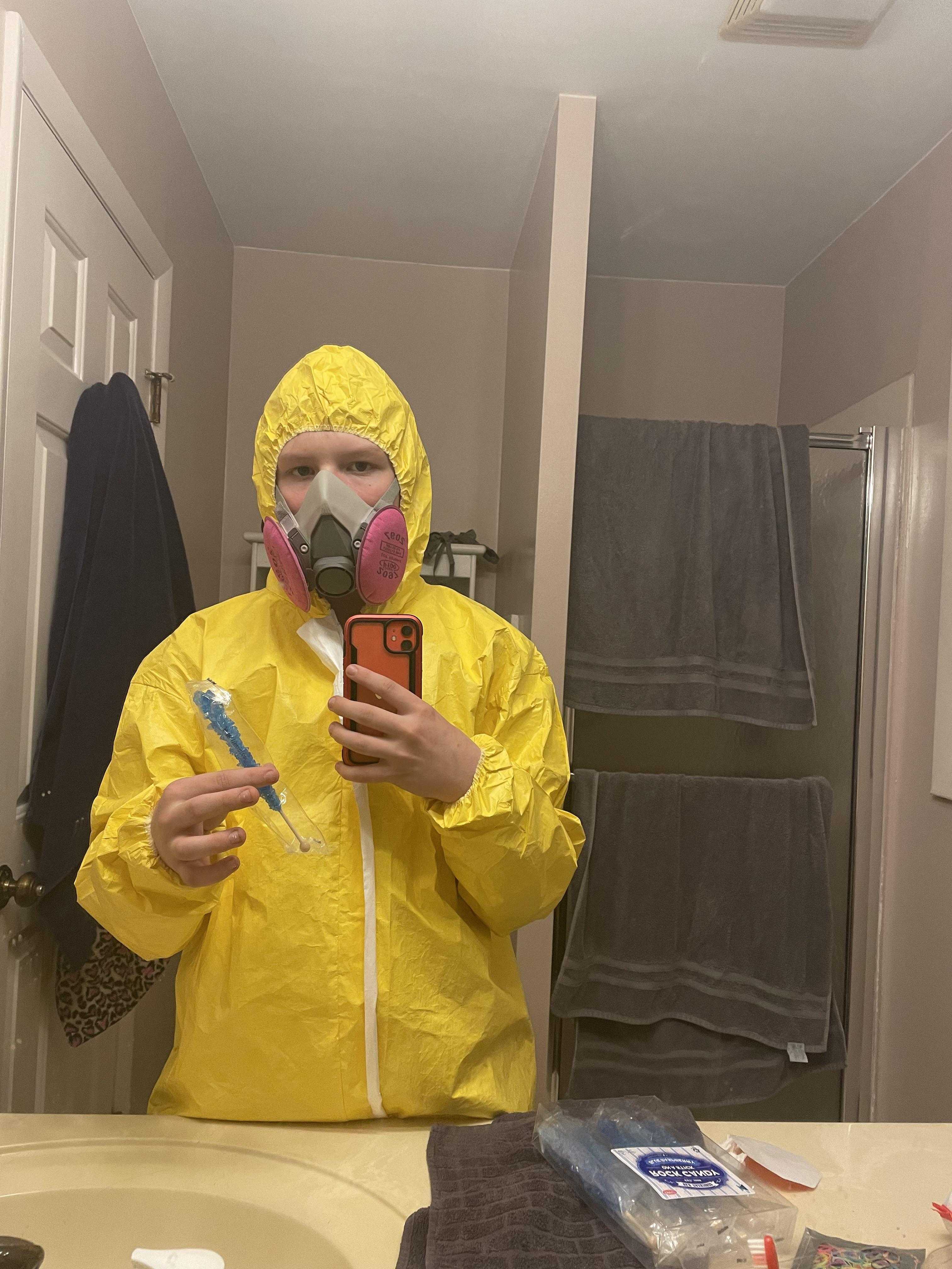 araffe in a yellow rain suit taking a selfie in a bathroom