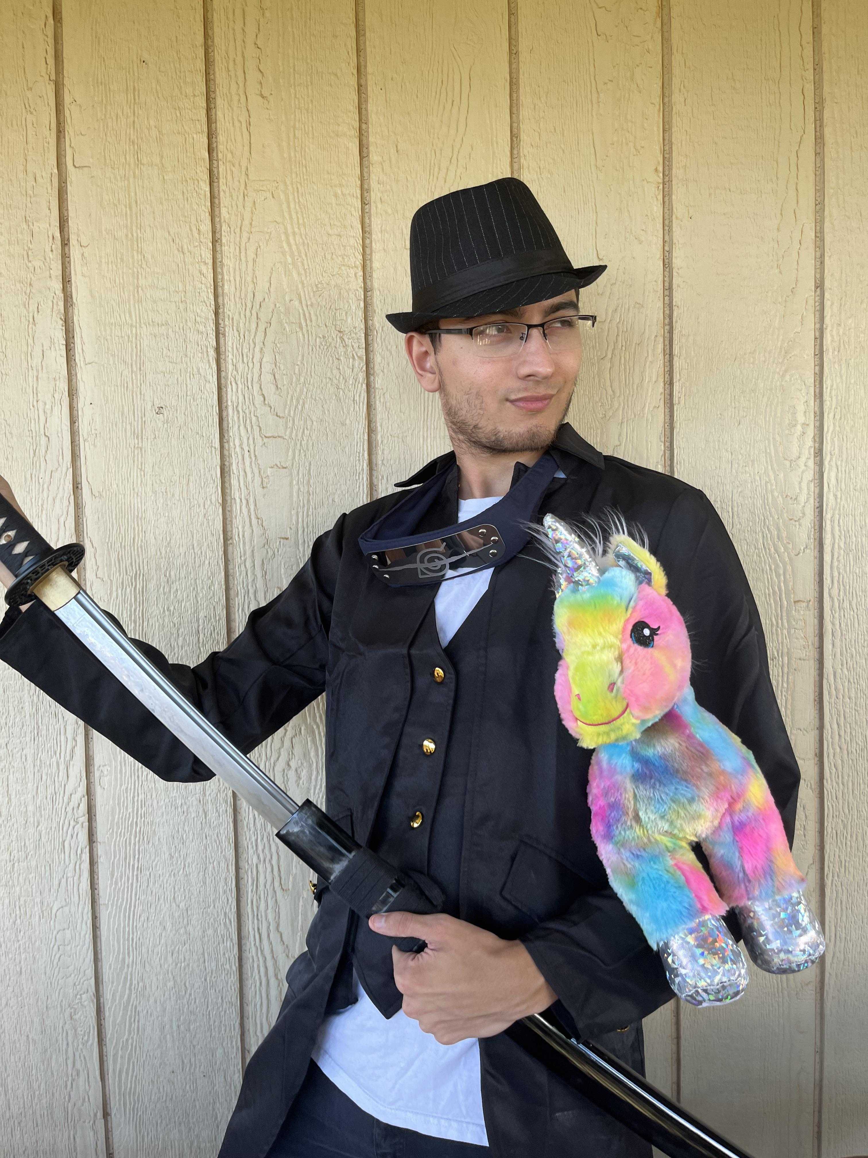 man in a black hat holding a gun and a stuffed animal