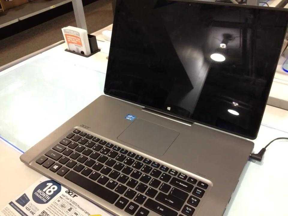 there is a laptop computer sitting on a table with a price tag