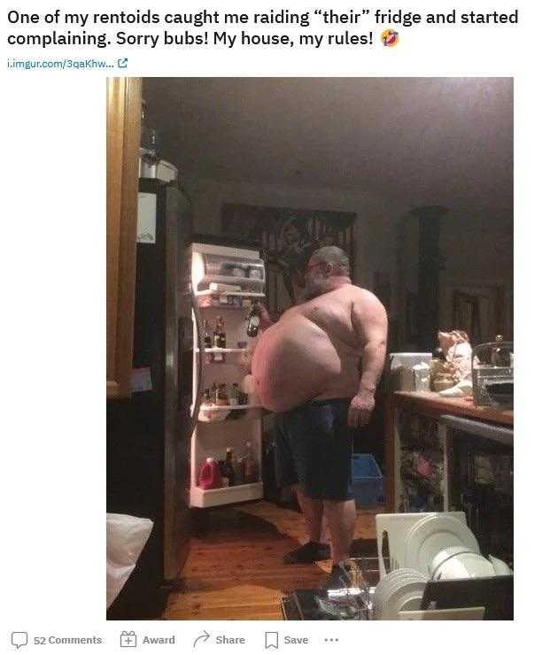 man standing in front of a refrigerator with a huge belly