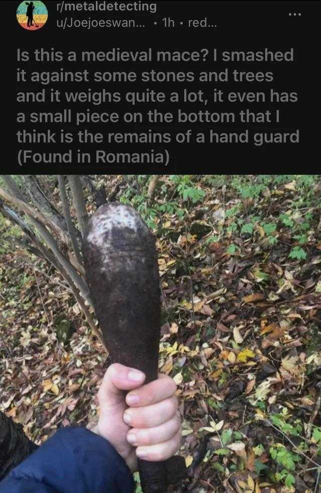 someone holding a large stone in their hand in the woods