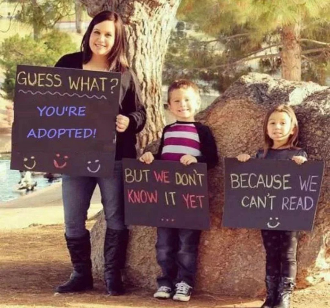 three children holding signs that read guess what you ' re adopted