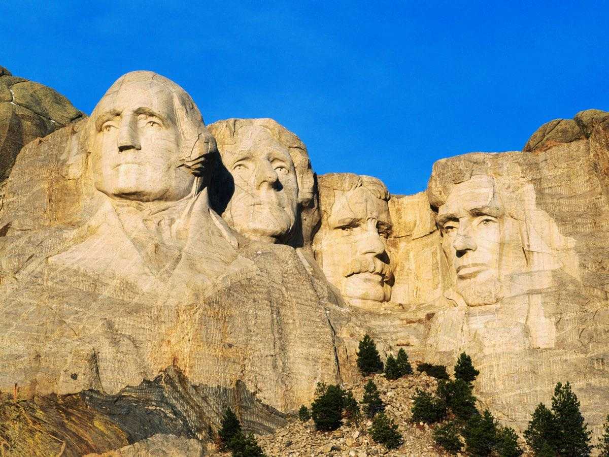 mountain with a group of carved faces on it