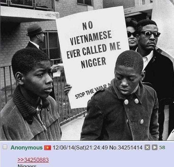 several men holding signs in front of a building with a sign saying no vietnamese ever called me nigger