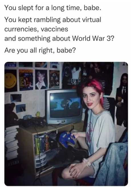 woman sitting at a desk with a computer and a video game controller